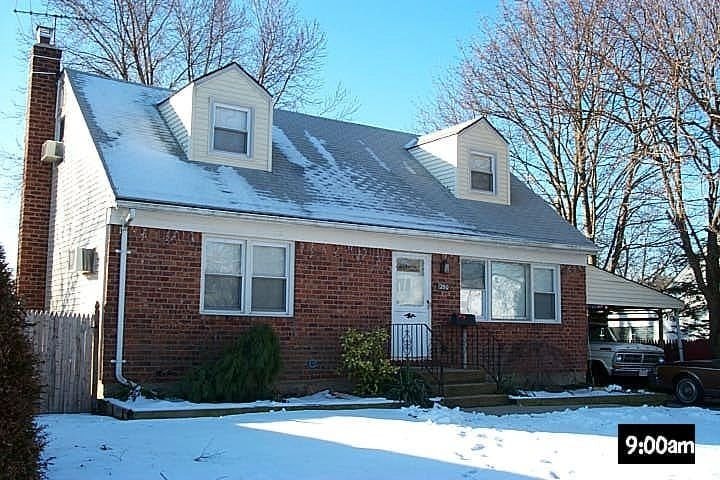 Brick home with snow-covered roof
